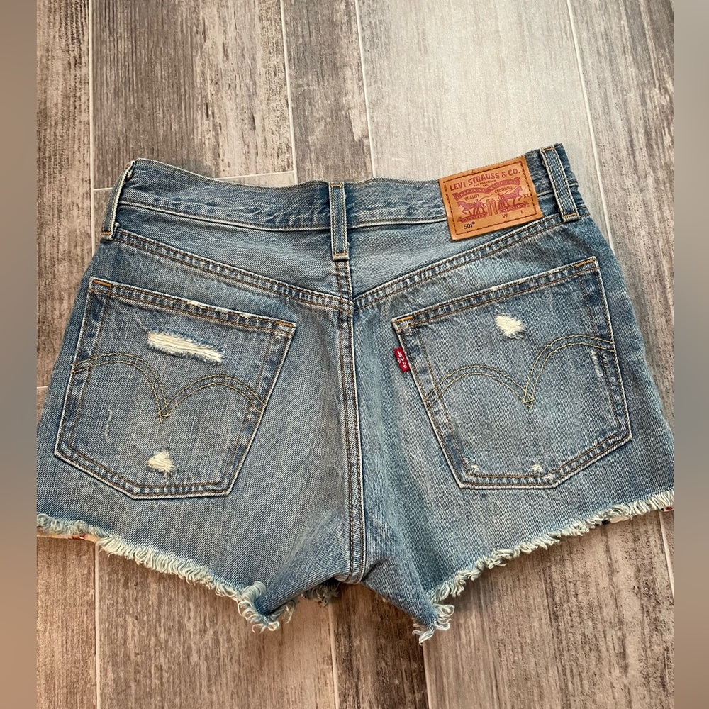 Levi’s 501 Women’s shorts. flower patched in the holes, size 26W